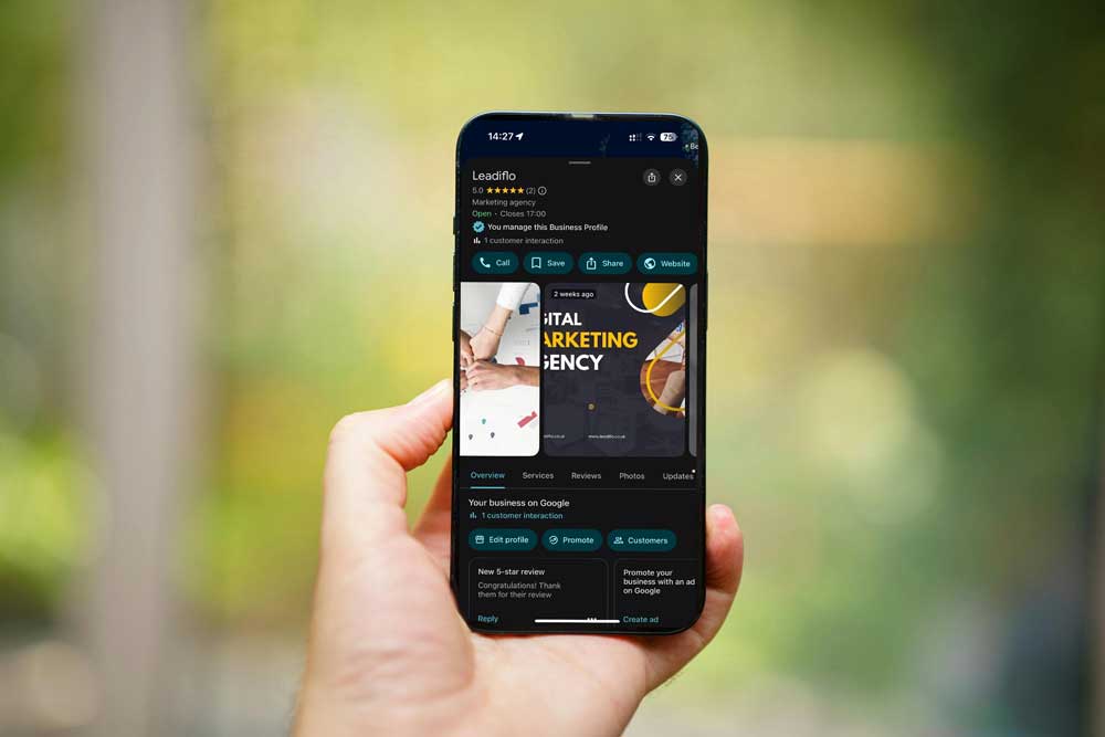 GMB-leadiflo A hand holding a smartphone displaying a Google business profile.